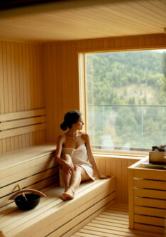 Attractive young woman relaxing in the sauna